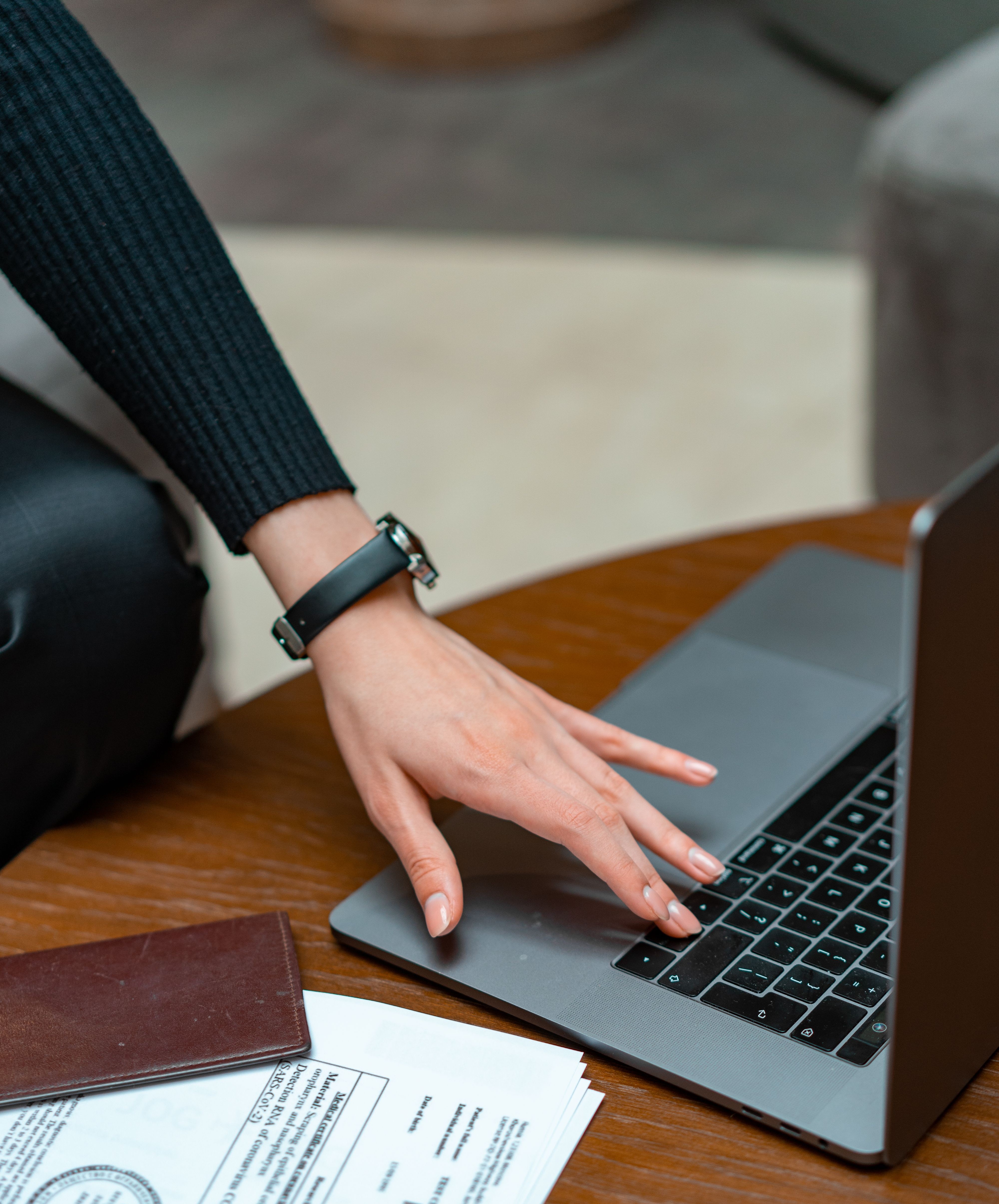 A laptop and paperwork on a desk
